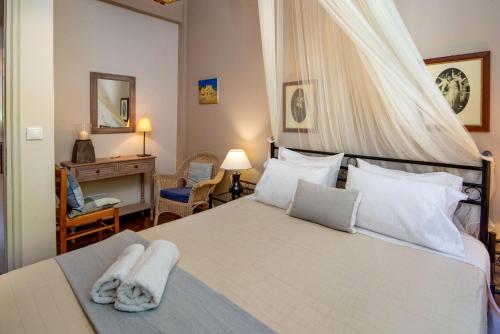 a bedroom with a bed with two towels on it at Villa Eleni Paxos in Gaios