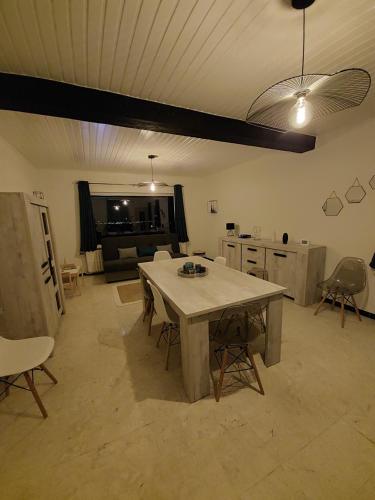 a kitchen with a table and chairs in a room at Agimon'TOIT in Hastière-par-delà