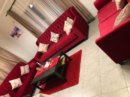 an overhead view of a living room with red furniture at شقة ثلاث غرف ,للعائلات فقط ,Sunrise Sunset1 in King Abdullah Economic City