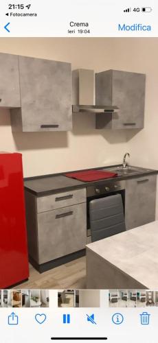 a kitchen with stainless steel appliances and a red refrigerator at senza pensieri residence zero carlo urbino in Crema