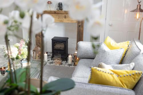 a living room with a couch and a fireplace at Stylish George Street Apartment in Peebles