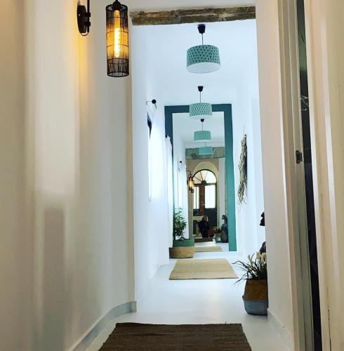 a hallway of a house with white walls and lights at 3 Bedroom piso in El pueblo de Javea in Jávea