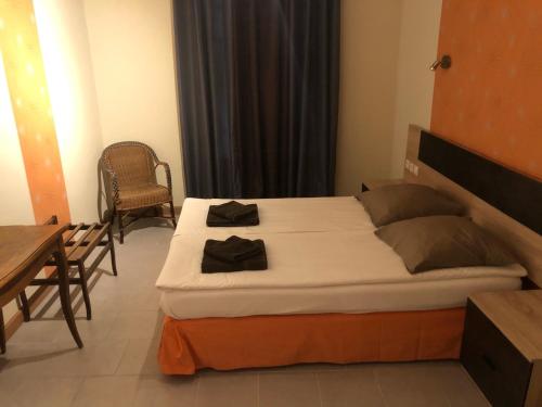 a bedroom with a bed and a table and chairs at La Châtaigneraie in Uzer