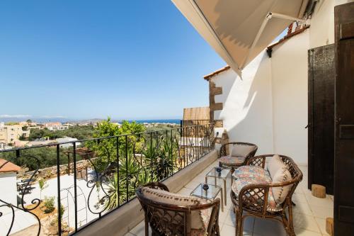 a balcony with chairs and a view of the ocean at Beit Petra in Daratso