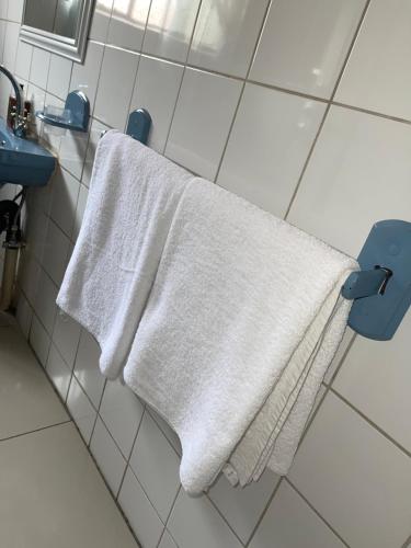 a white towel hanging on a towel rack in a bathroom at Motjatji B&B in Burgersfort