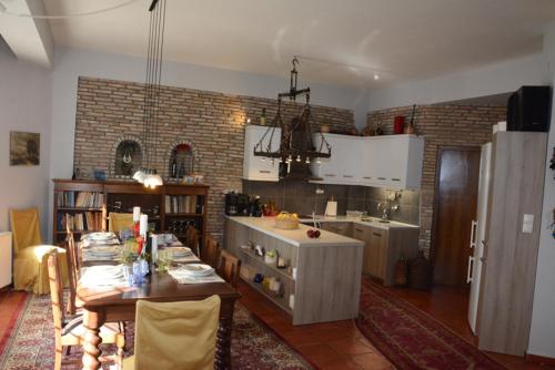 a kitchen with a table and a dining room at Kalavrita Mountain Resort in Kalavrita