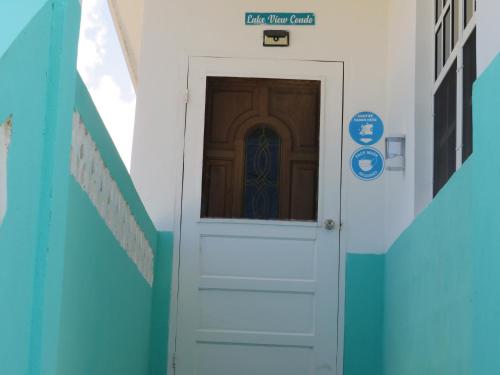 a door with a sign that reads last time caller at LAKE VIEW CONDO in Belize City