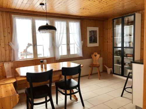 a dining room with a wooden table and chairs at Chalet Pironnet with BEST Views, Charm and Comfort! in Lauterbrunnen