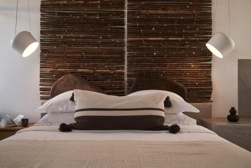 a bedroom with a bed with two lights on it at Casa Cabana Boutique Hotel & Spa - Adults Only in Faliraki