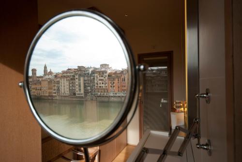 a reflection of a mirror on a wall of a building at Hotel Continentale - Lungarno Collection in Florence