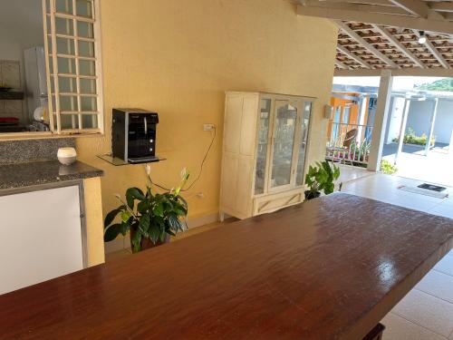 a kitchen with a wooden table in a room at Pousada Xero in Capitólio