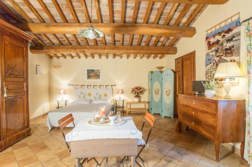 a bedroom with a bed and a table and chairs at Podere Sette Piagge in Orvieto