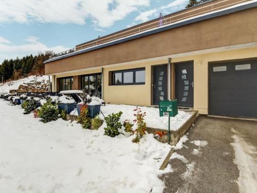 a house with a lot of snow in front of it at Beautiful cottage in La Chaux with jacuzzi in La Chaux