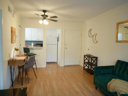 a living room with a green couch and a table at Cozy Condo near Buckhead in Atlanta