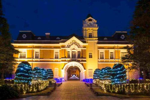 a building with christmas lights in front of it at Hotel Lifetree Hitachinoushiku in Ushiku