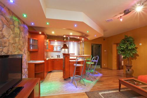 a kitchen and living room with a stone wall at Pałac Saturna in Czeladź