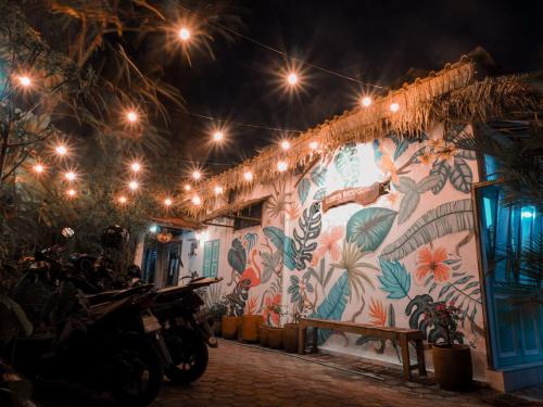 a building with a colorful mural with lights on it at Laura's Backpacker 523 in Yogyakarta