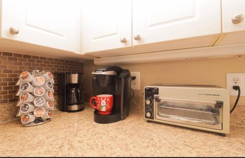 a kitchen counter with a toaster and a coffee maker at 5 star luxury 1 bedroom condo in Orlando