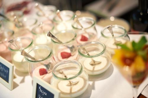 a bunch of glasses with strawberries in them on a table at Parkhotel Obermenzing in Munich