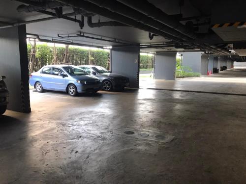 two cars parked in an empty parking lot at Politan Breeze, Chaophraya River view in Ban Sai Ma