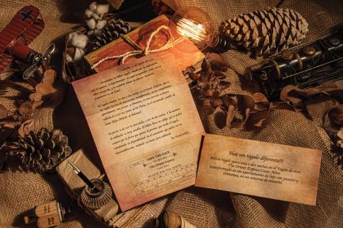 a book on top of a blanket with other items at Vagón Orient Express - Housevanlive in Casas Altas