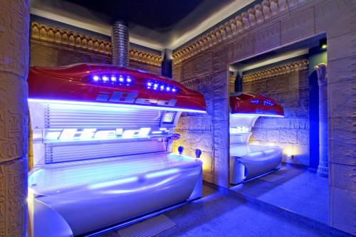 a room with two beds with lights in it at Pałac Saturna in Czeladź