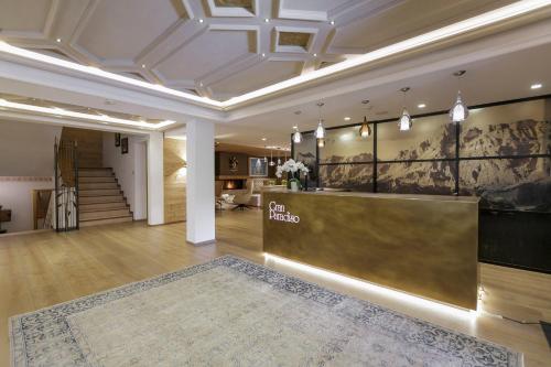 a lobby with a reception desk in a building at Hotel Gran Paradiso in San Cassiano