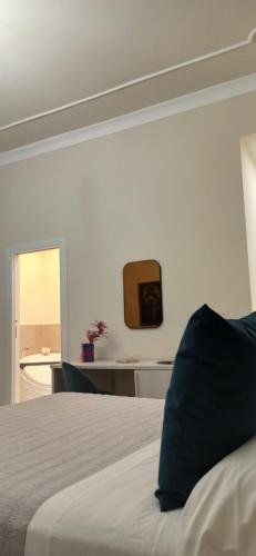 a bedroom with a bed and a mirror on the wall at Amaris in Palermo