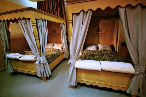 two beds with hay on them in a room at Pałac Saturna in Czeladź