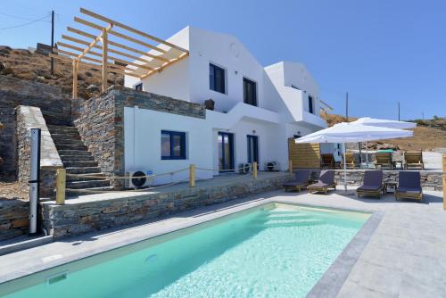 a villa with a swimming pool and a house at Kea live in Blue Villa with Pool - Cyclades in Melissaki