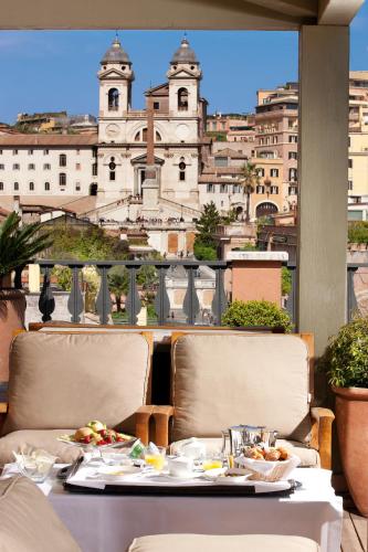 a table with food on it with a view of a building at Portrait Roma - Lungarno Collection in Rome