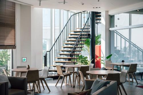 a staircase in a room with tables and chairs at Sunlight On the Peninsula in Eluan