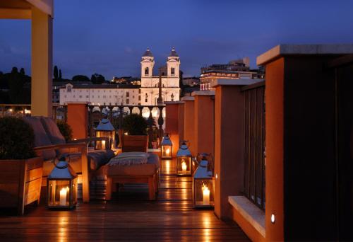 a balcony with lights and a view of a building at Portrait Roma - Lungarno Collection in Rome
