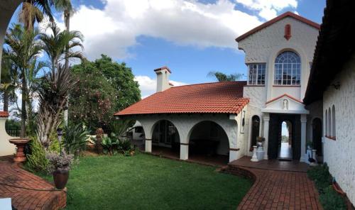 a large white house with a red roof at THEE VIEW in Hartbeespoort