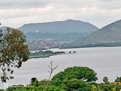 a view of a lake with mountains in the background at THEE VIEW in Hartbeespoort