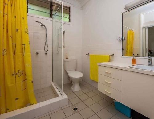 a bathroom with a shower and a toilet and a sink at Nature Retreat on Mandalay in Nelly Bay