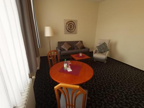 a living room with a table and a couch at Badhotel Bad Brückenau in Staatsbad Brückenau