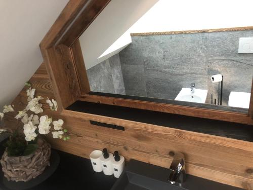 a bathroom with a mirror and a sink at Appartements Innerkofler Mountain Home in San Candido