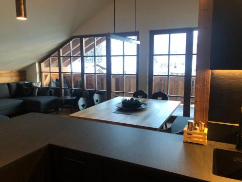 a living room with a table and a couch at Appartements Innerkofler Mountain Home in San Candido