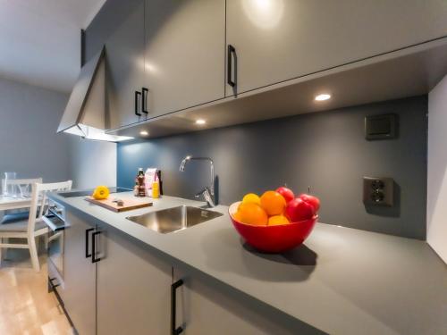 a bowl of fruit on a counter in a kitchen at Uppsala Hotel Apartments in Uppsala
