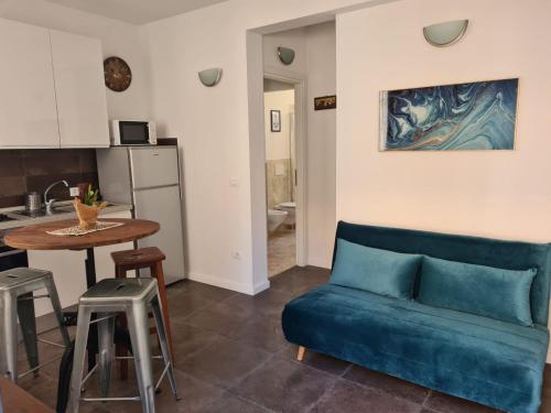 a living room with a blue couch and a table at FLORENCE QUARTERS in Florence