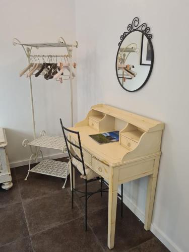 a wooden desk with a chair and a mirror at FLORENCE QUARTERS in Florence