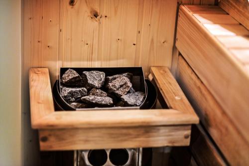a box of rocks sitting on a wooden shelf at Apartament LOFTSPA in Ustrzyki Dolne