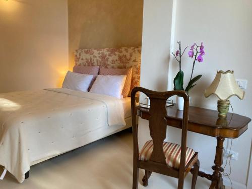 a bedroom with a bed and a table with a lamp at Villa Lina in Tremezzo