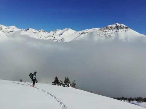 a person is skiing down a snow covered mountain at Familiehotel La Randulina in Ramosch