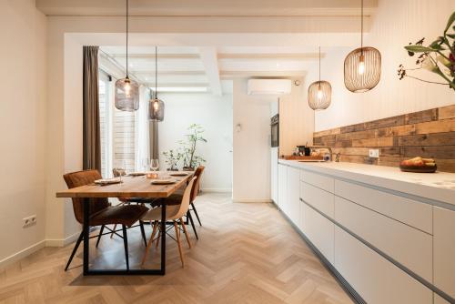 a kitchen and dining room with a table and chairs at Leidse Square 5 star Luxury Apartment in Amsterdam
