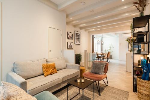 a living room with a couch and a table at Leidse Square 5 star Luxury Apartment in Amsterdam