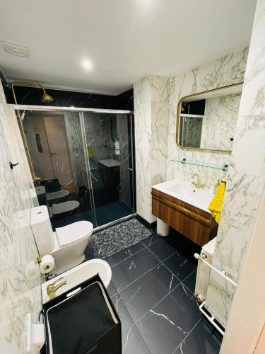 a bathroom with a shower and a toilet and a sink at Stunning 2 bedroom Apartment with great design Sitges centre beach in Sitges