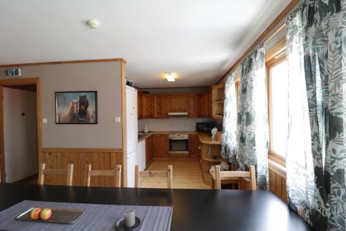 a kitchen and dining room with a table and chairs at Fossanmoen in Forsand