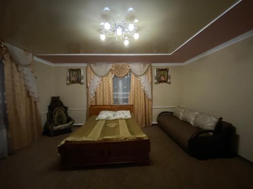 a bedroom with a bed and a chandelier at Plavianska Sadyba in Plav'ya